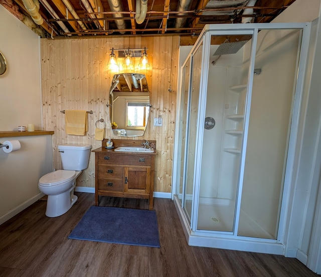 45257 Jack Pine Dr, Perham Twp, MN 56573 - full bathroom featuring a shower stall, vanity, wood finished floors, toilet, and wooden walls
