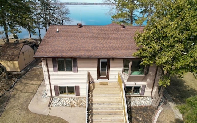 45257 Jack Pine Dr, Perham Twp, MN 56573 - view of front of home with roof with shingles, stairs, and a water view