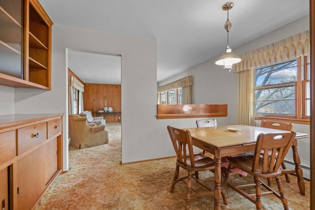 dining space featuring carpet floors and baseboards