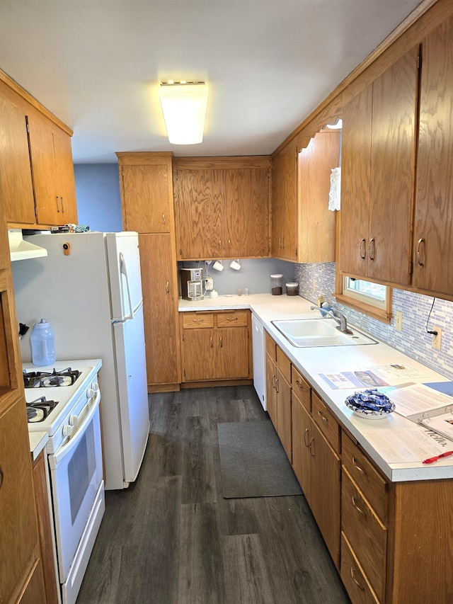 719 49th Ave NE, Columbia Heights, MN 55421 - kitchen with a sink, white appliances, dark wood finished floors, light countertops, and decorative backsplash