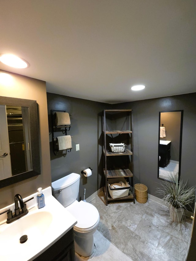 719 49th Ave NE, Columbia Heights, MN 55421 - bathroom with vanity, toilet, and baseboards