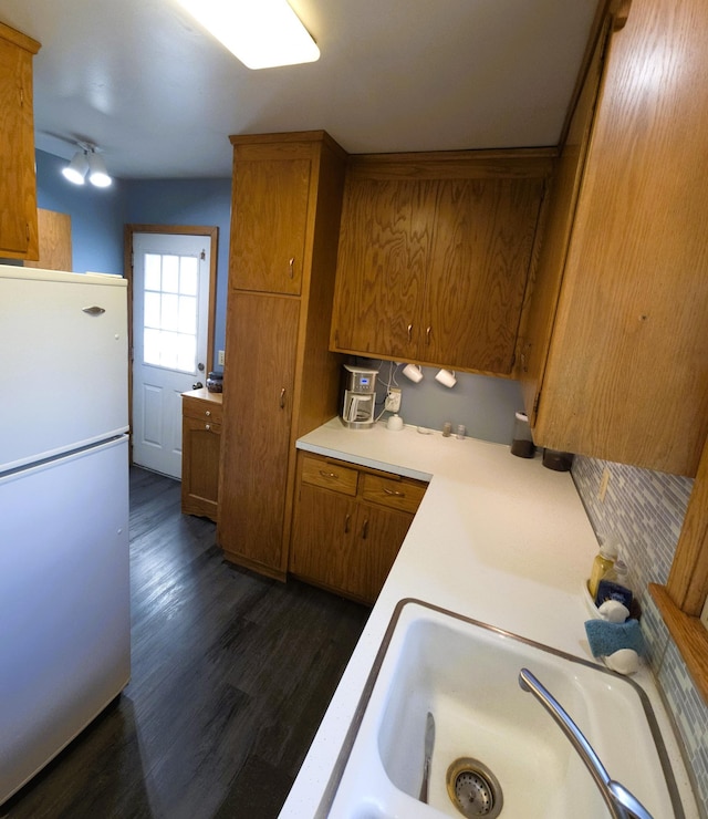 719 49th Ave NE, Columbia Heights, MN 55421 - kitchen featuring freestanding refrigerator, brown cabinets, light countertops, a sink, and dark wood finished floors