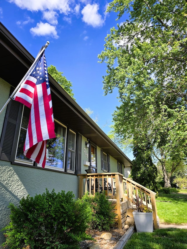 719 49th Ave NE, Columbia Heights, MN 55421 - view of property exterior with stucco siding and a wooden deck