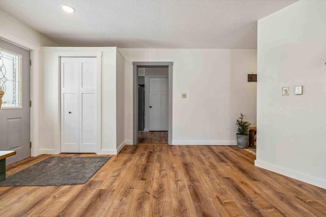 14347 Memorywood Dr, Baxter, MN 56425 - entryway featuring baseboards, recessed lighting, wood finished floors, and a textured ceiling