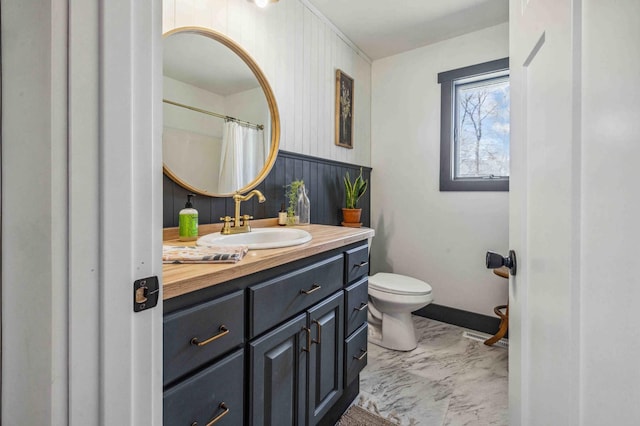14347 Memorywood Dr, Baxter, MN 56425 - bathroom with visible vents, toilet, vanity, marble finish floor, and wainscoting