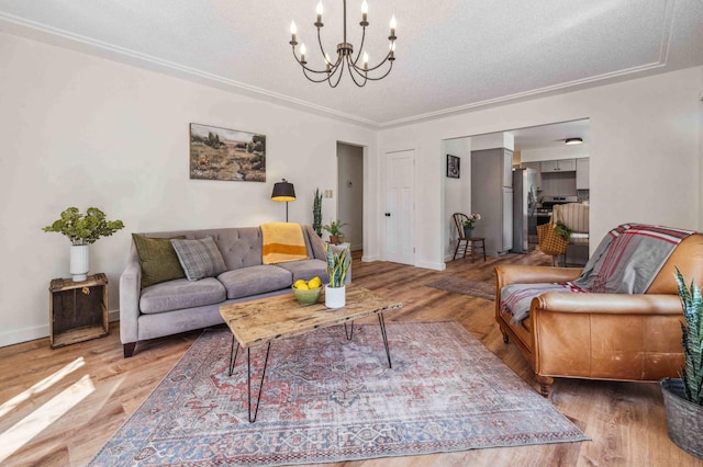 14347 Memorywood Dr, Baxter, MN 56425 - living area featuring a textured ceiling, wood finished floors, a notable chandelier, and baseboards