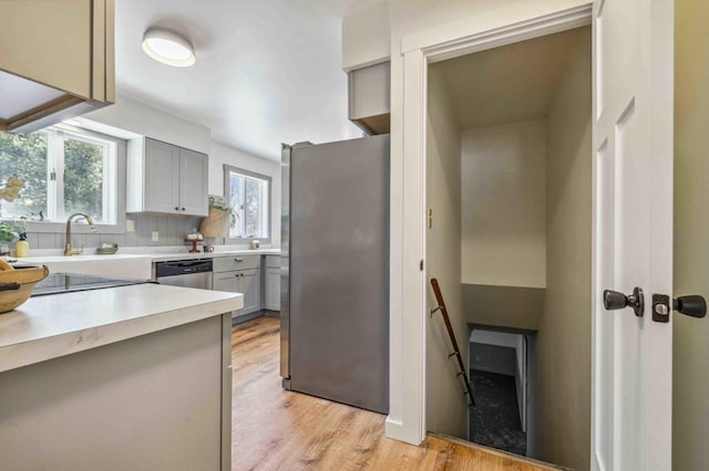 14347 Memorywood Dr, Baxter, MN 56425 - kitchen with light wood finished floors, a sink, light countertops, gray cabinetry, and appliances with stainless steel finishes