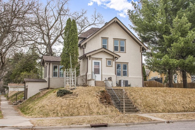 view of front of property featuring fence and brick siding