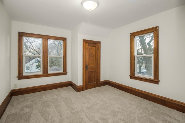 additional living space featuring carpet floors, baseboards, and a healthy amount of sunlight