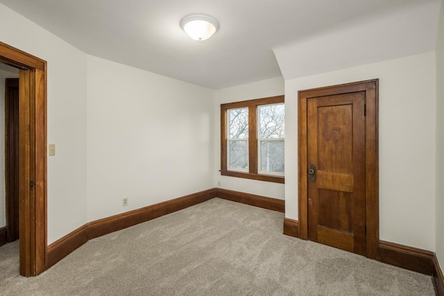 carpeted spare room with baseboards