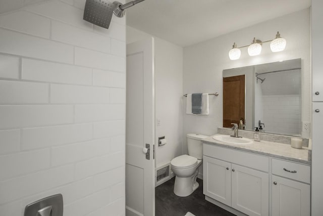 full bathroom with toilet, walk in shower, vanity, and visible vents