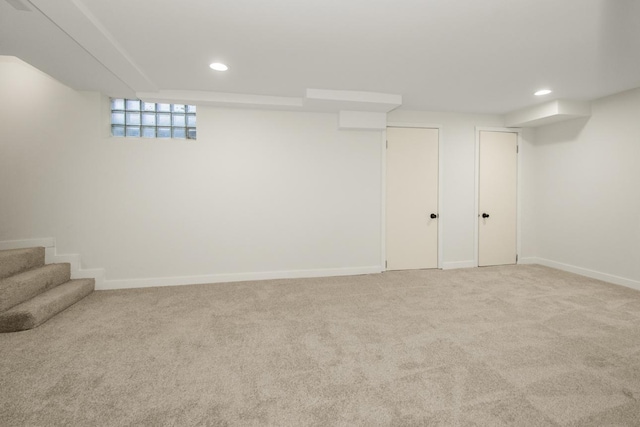 below grade area featuring carpet floors, baseboards, and recessed lighting