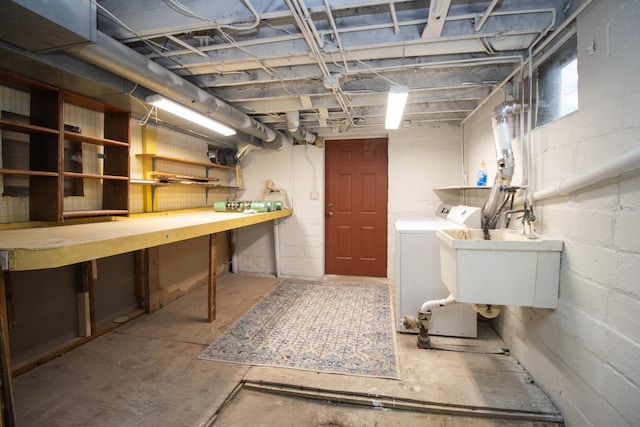 below grade area featuring independent washer and dryer, a workshop area, and a sink