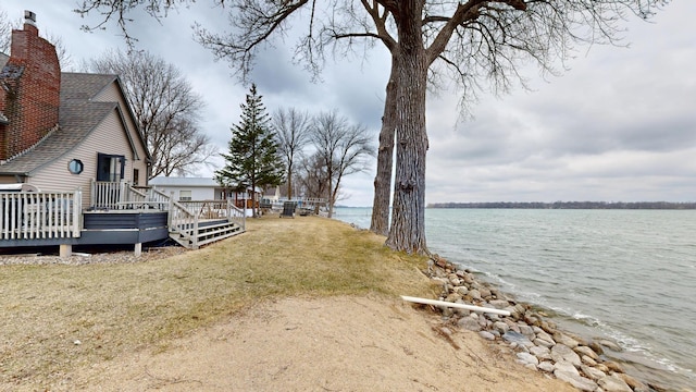 7030 147th Ave SE, Lake Lillian, MN 56253 - view of grassy yard with a deck with water view