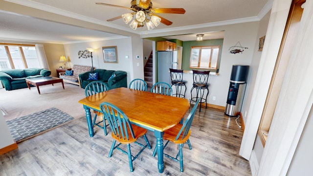 7030 147th Ave SE, Lake Lillian, MN 56253 - dining room with plenty of natural light, stairs, a ceiling fan, wood finished floors, and crown molding