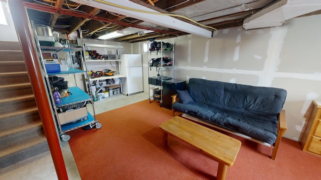 7030 147th Ave SE, Lake Lillian, MN 56253 - unfinished below grade area with freestanding refrigerator, stairs, and carpet floors