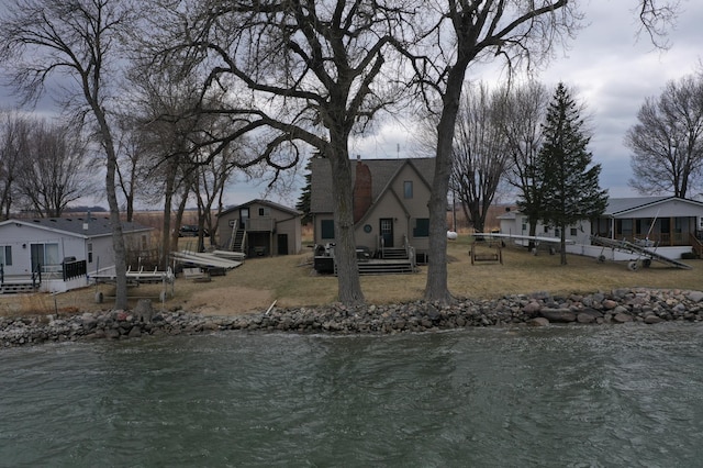 7030 147th Ave SE, Lake Lillian, MN 56253 - view of front facade with a deck with water view and a front lawn