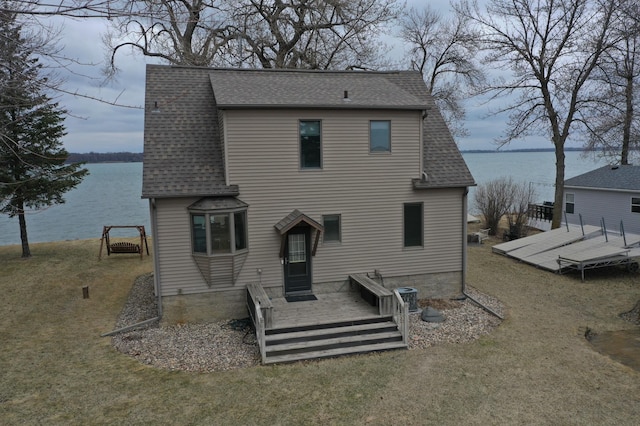 7030 147th Ave SE, Lake Lillian, MN 56253 - back of property with roof with shingles, a deck with water view, and a yard