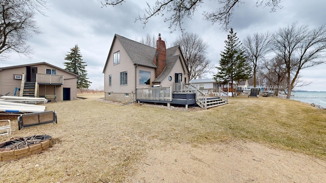 7030 147th Ave SE, Lake Lillian, MN 56253 - back of property with a chimney, a deck with water view, a shingled roof, and a yard