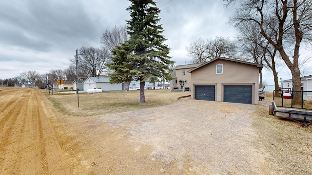 7030 147th Ave SE, Lake Lillian, MN 56253 - view of front of house featuring dirt driveway, a garage, and fence