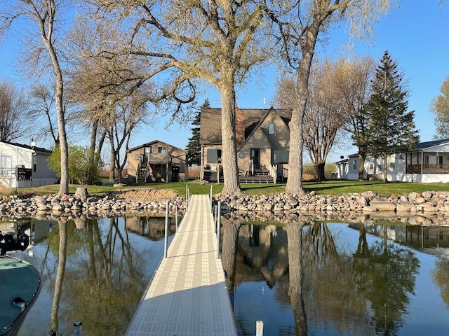 7030 147th Ave SE, Lake Lillian, MN 56253 - dock area featuring a residential view, a lawn, and a water view