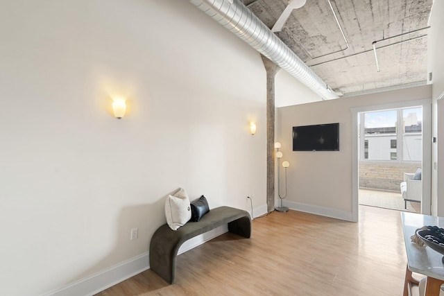 sitting room with light wood-style flooring and baseboards