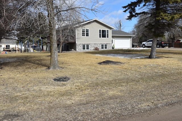 209 2nd Ave N, Viking, MN 56760 - exterior space featuring an attached garage, a front lawn, and a playground