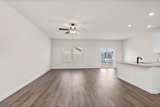 18761 Grant St NW, Elk River, MN 55330 - unfurnished living room featuring a ceiling fan, wood finished floors, and recessed lighting