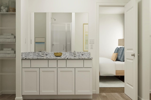 18761 Grant St NW, Elk River, MN 55330 - ensuite bathroom with wood finished floors, a shower stall, and double vanity