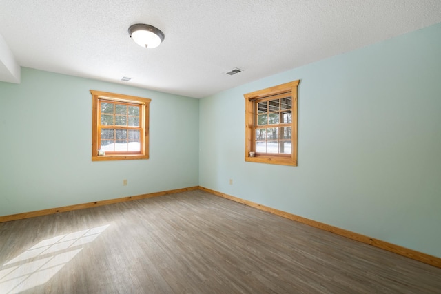21339 Finch Dr, Park Rapids, MN 56470 - spare room featuring wood finished floors, baseboards, and a textured ceiling