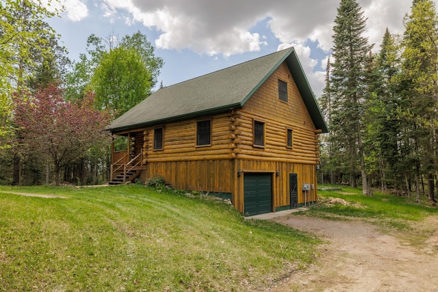 21339 Finch Dr, Park Rapids, MN 56470 - view of side of property with log siding, driveway, a lawn, and a garage