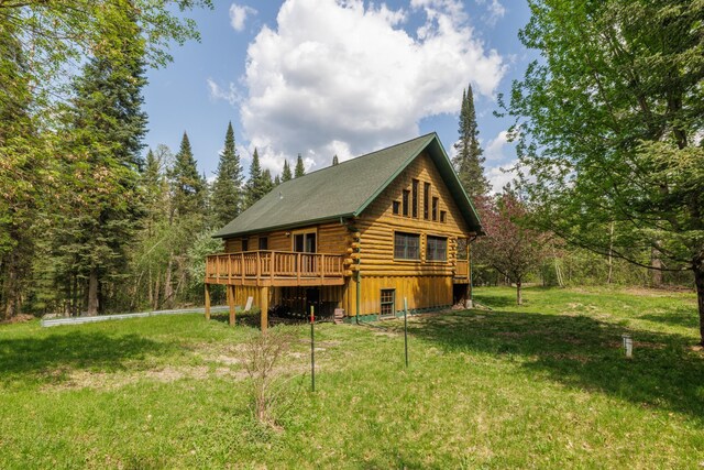 21339 Finch Dr, Park Rapids, MN 56470 - back of property with log siding, a wooden deck, and a yard