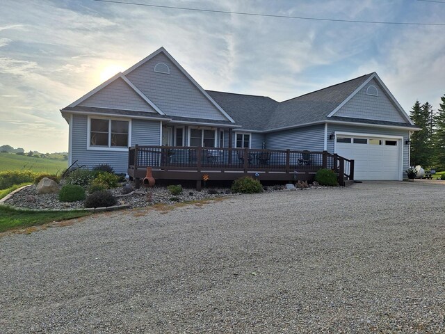 3195 115th St NW, Oronoco, MN 55960 - view of front of home featuring an attached garage, driveway, a wooden deck, and roof with shingles