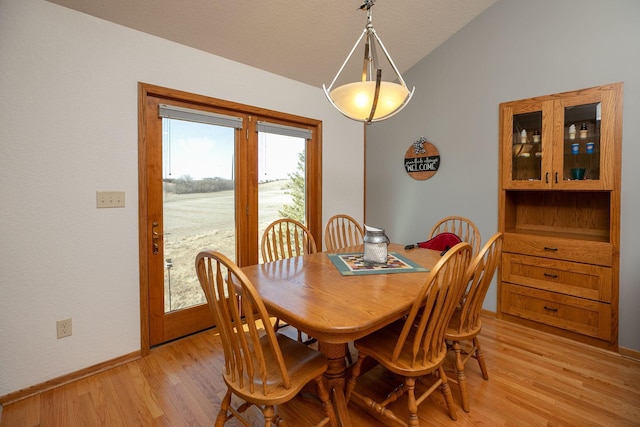 3195 115th St NW, Oronoco, MN 55960 - dining room with vaulted ceiling, light wood-type flooring, and baseboards