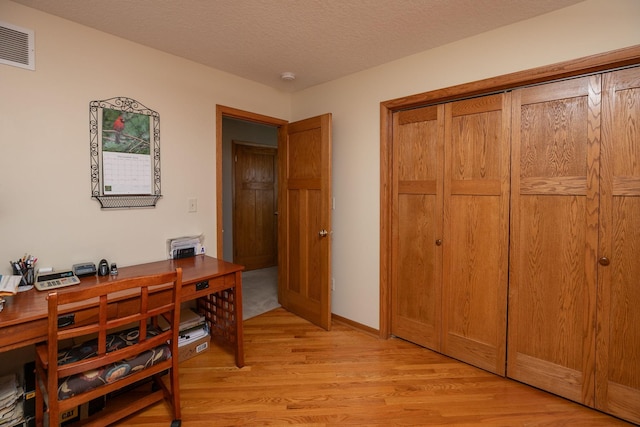 3195 115th St NW, Oronoco, MN 55960 - home office featuring light wood-style floors and a textured ceiling