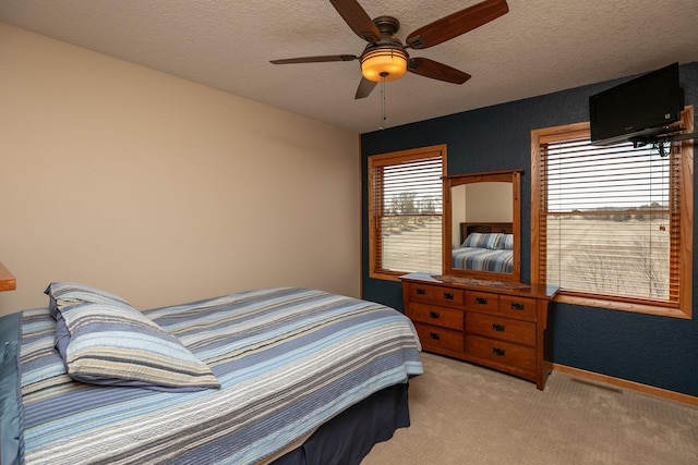 3195 115th St NW, Oronoco, MN 55960 - bedroom with light colored carpet, a textured ceiling, a ceiling fan, and baseboards