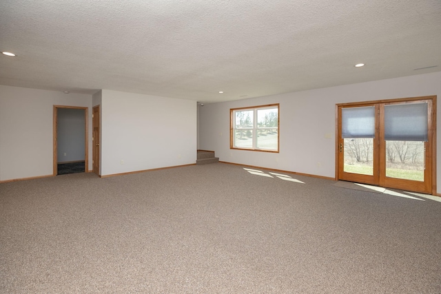 3195 115th St NW, Oronoco, MN 55960 - carpeted empty room featuring baseboards, a textured ceiling, recessed lighting, and stairway