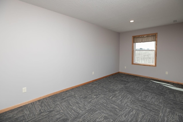 3195 115th St NW, Oronoco, MN 55960 - empty room featuring baseboards, dark colored carpet, recessed lighting, and a textured ceiling