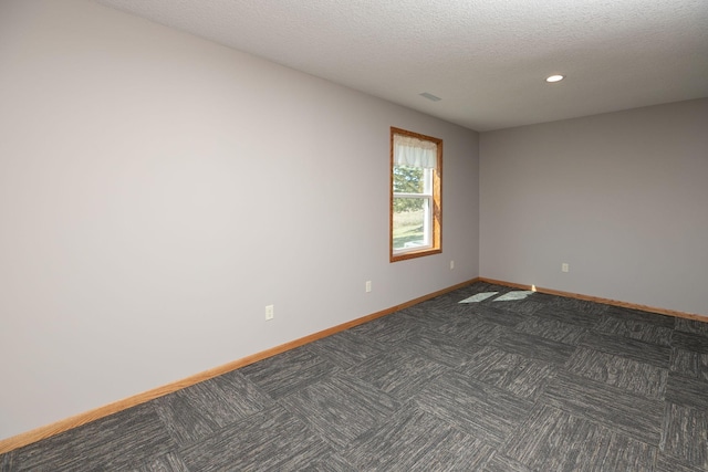 3195 115th St NW, Oronoco, MN 55960 - spare room featuring baseboards, dark carpet, recessed lighting, and a textured ceiling