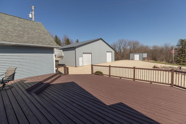 3195 115th St NW, Oronoco, MN 55960 - wooden deck featuring an outdoor structure, a detached garage, and a storage shed