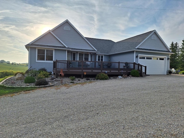 3195 115th St NW, Oronoco, MN 55960 - view of front of property featuring a garage, driveway, a wooden deck, and a shingled roof