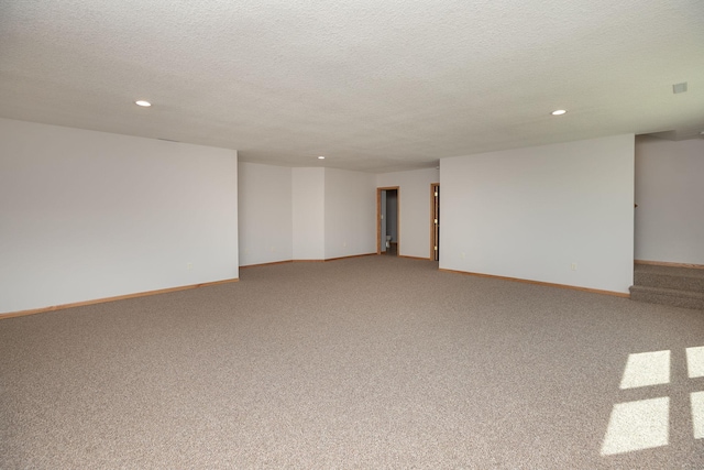 3195 115th St NW, Oronoco, MN 55960 - spare room featuring recessed lighting, light colored carpet, a textured ceiling, and baseboards