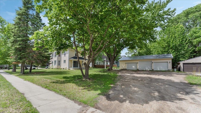 723 3rd St SW, Willmar, MN 56201 - view of front of home with a garage, an outbuilding, and a front lawn