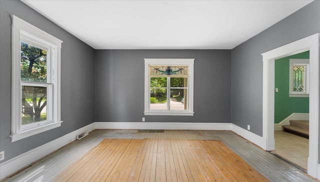 723 3rd St SW, Willmar, MN 56201 - empty room with healthy amount of natural light, wood-type flooring, and baseboards