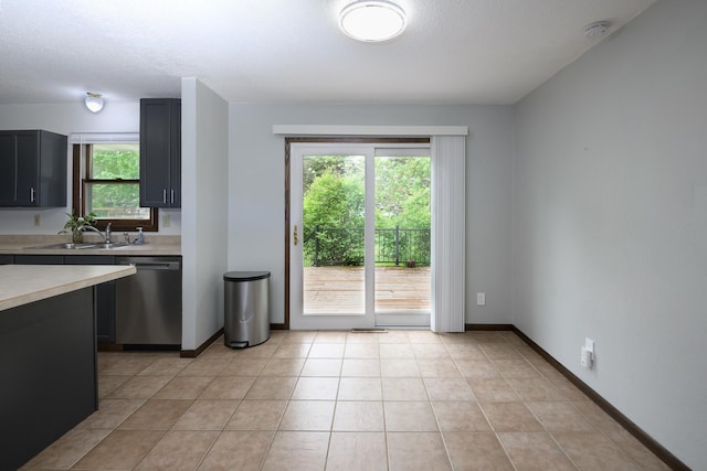 6330 Kenwood Rd, Saint Cloud, MN 56303 - kitchen featuring a sink, dishwasher, light countertops, light tile patterned flooring, and a textured ceiling