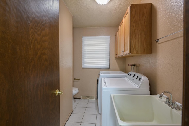6330 Kenwood Rd, Saint Cloud, MN 56303 - clothes washing area featuring a sink, independent washer and dryer, light tile patterned floors, and a textured ceiling