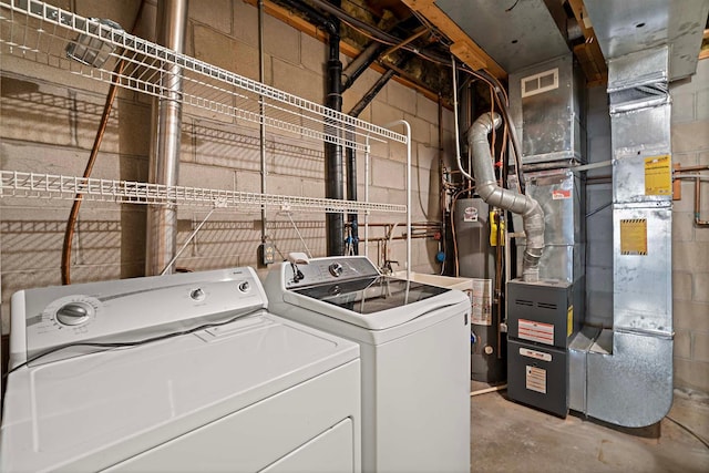 washroom with washing machine and dryer and heating unit
