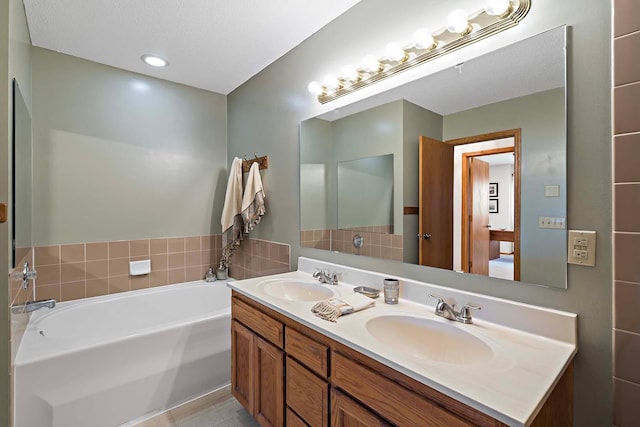 full bath with a bath and double vanity