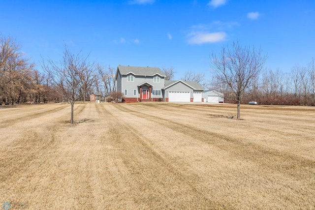 3358 70th Ave N, Moorhead, MN 56560 - view of front facade featuring a front yard, a garage, and driveway