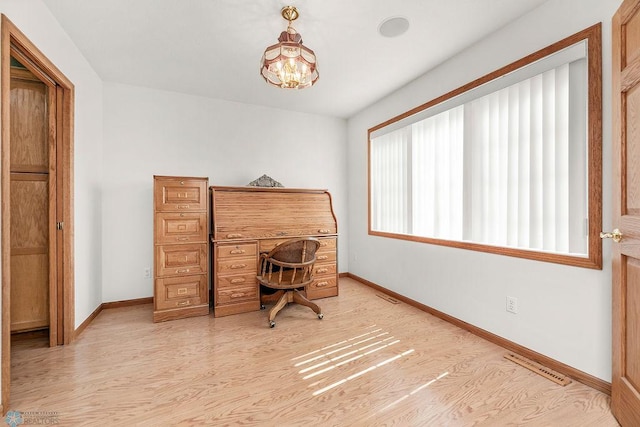 3358 70th Ave N, Moorhead, MN 56560 - office space featuring baseboards, light wood-style floors, and a chandelier